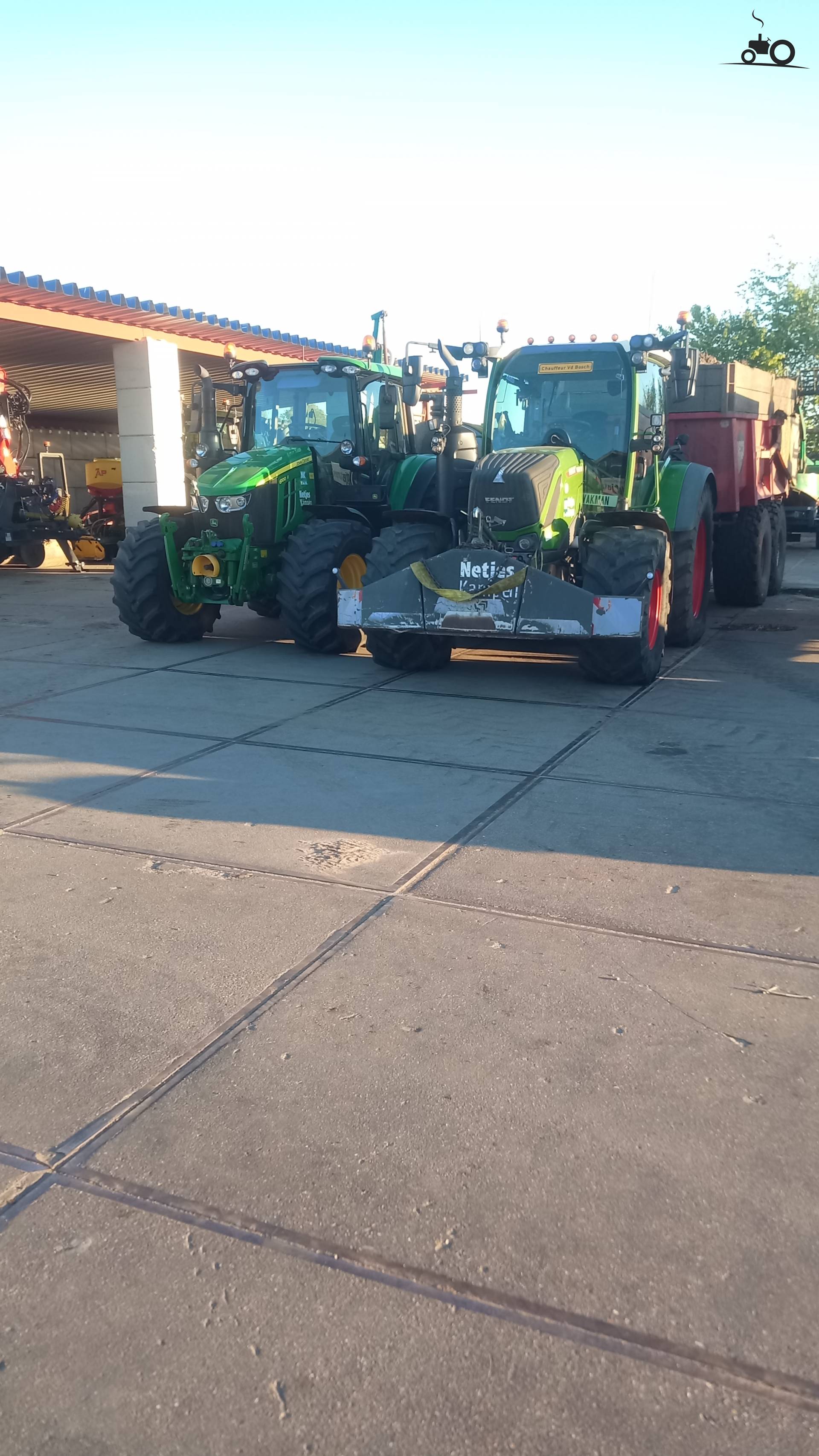 John Deere 6100M tractor next to a Fendt 313 Vario