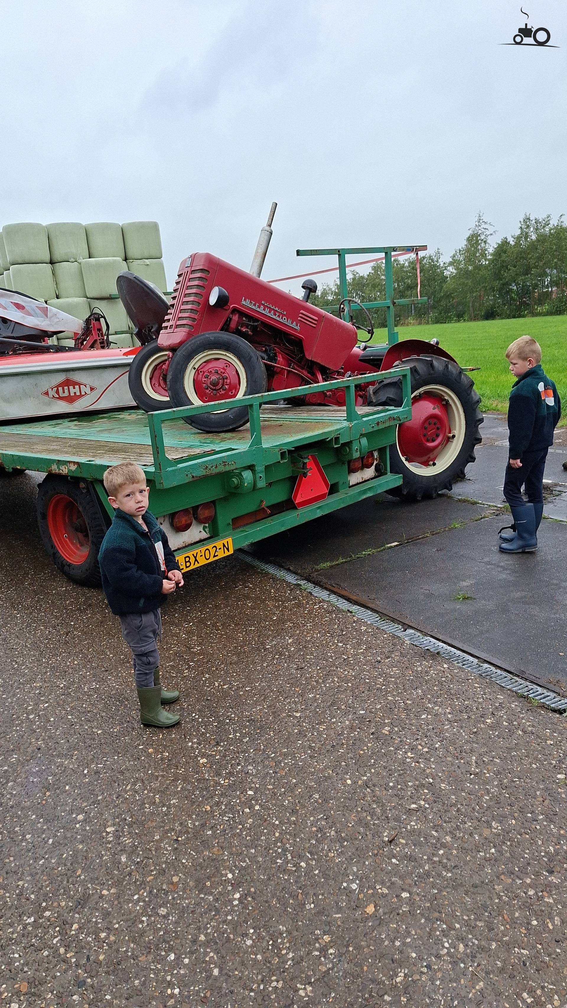 Tractor loaded onto the trailer with a forklift.