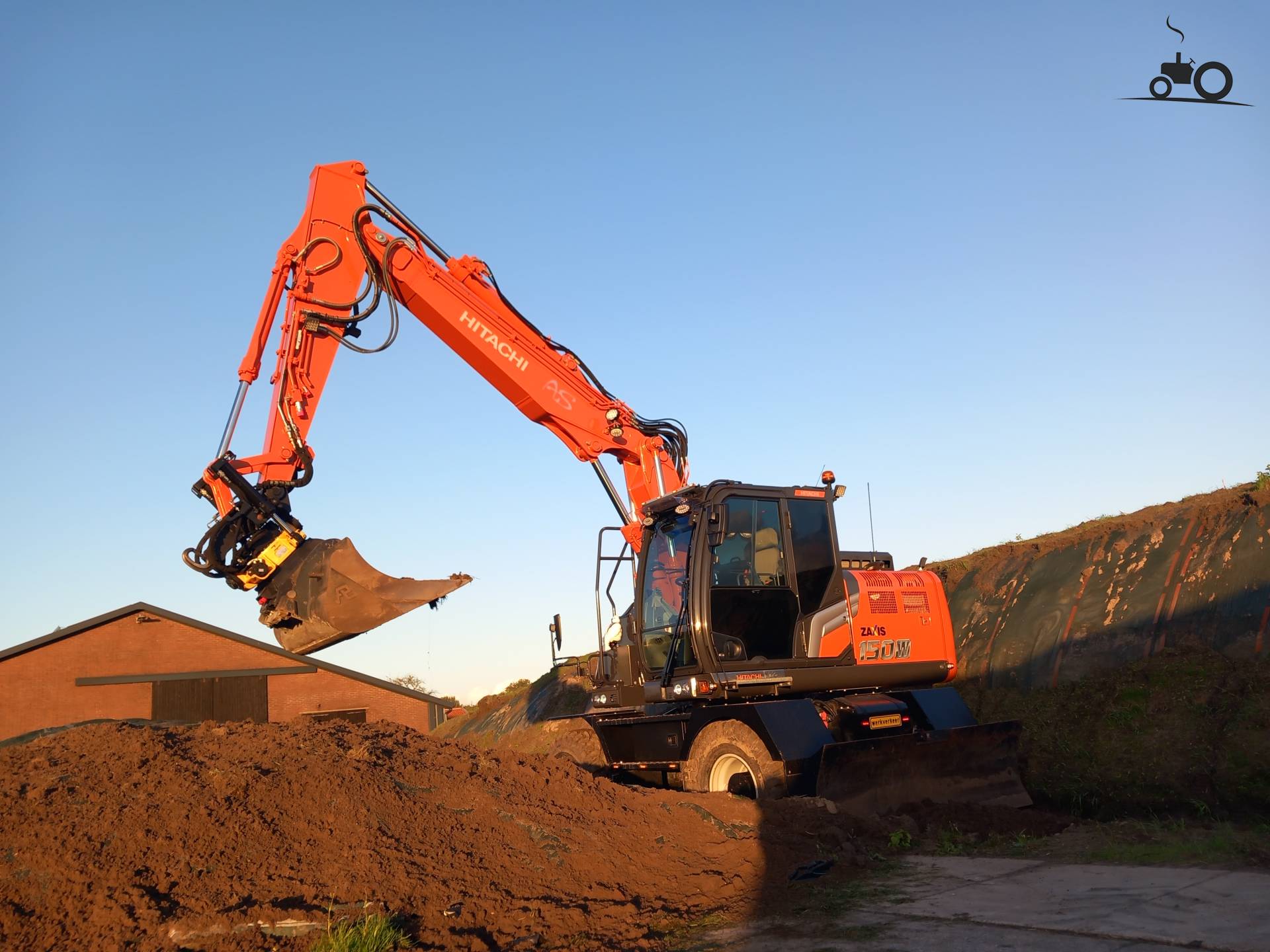 A Hitachi ZX150W-7 covering a silage clamp on a beautiful evening.