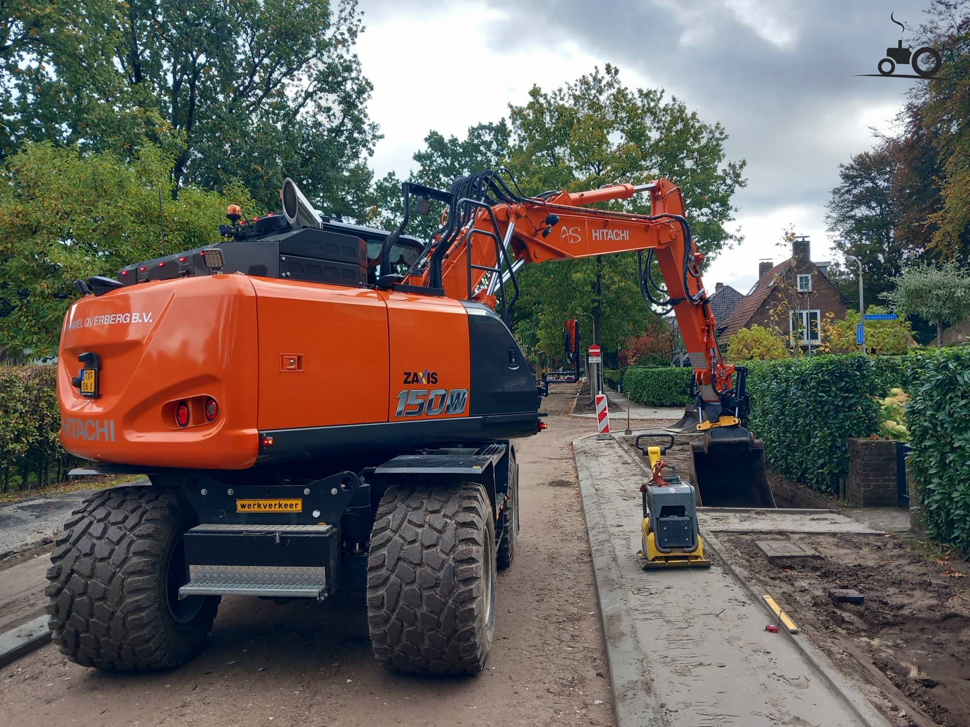 Hitachi ZX150W-7 excavator working on a residential neighborhood ...